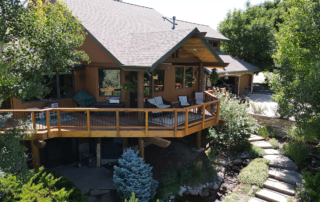 second story wrap around wood deck with a roof cover