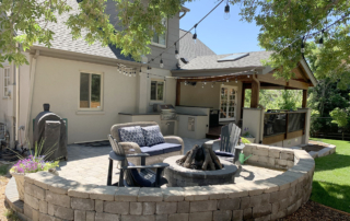 custom roof covered wood deck connected to a paver patio