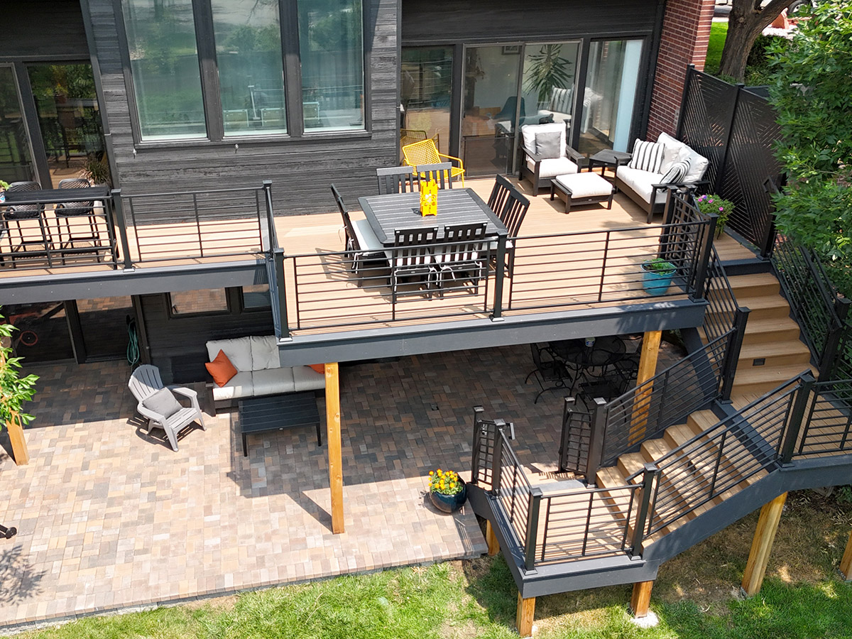 overview of an elevated deck above a paver patio