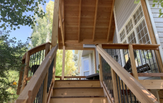 elevated custom wood deck with a roof cover