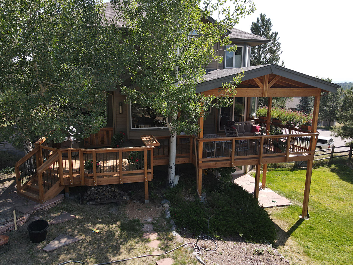 multi-level custom wood deck with a roofcover