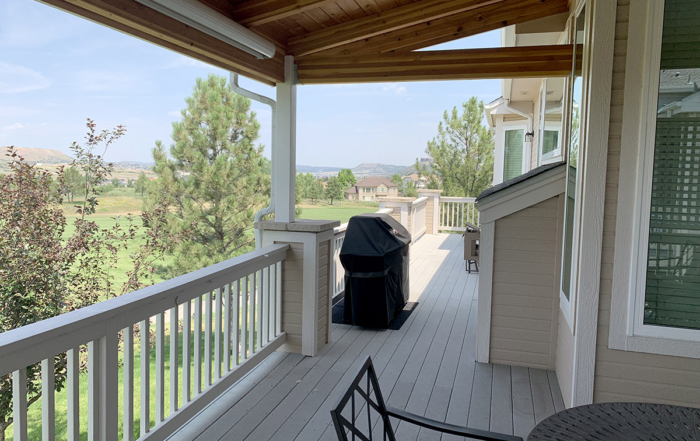 a long elevated deck with a roof cover over half